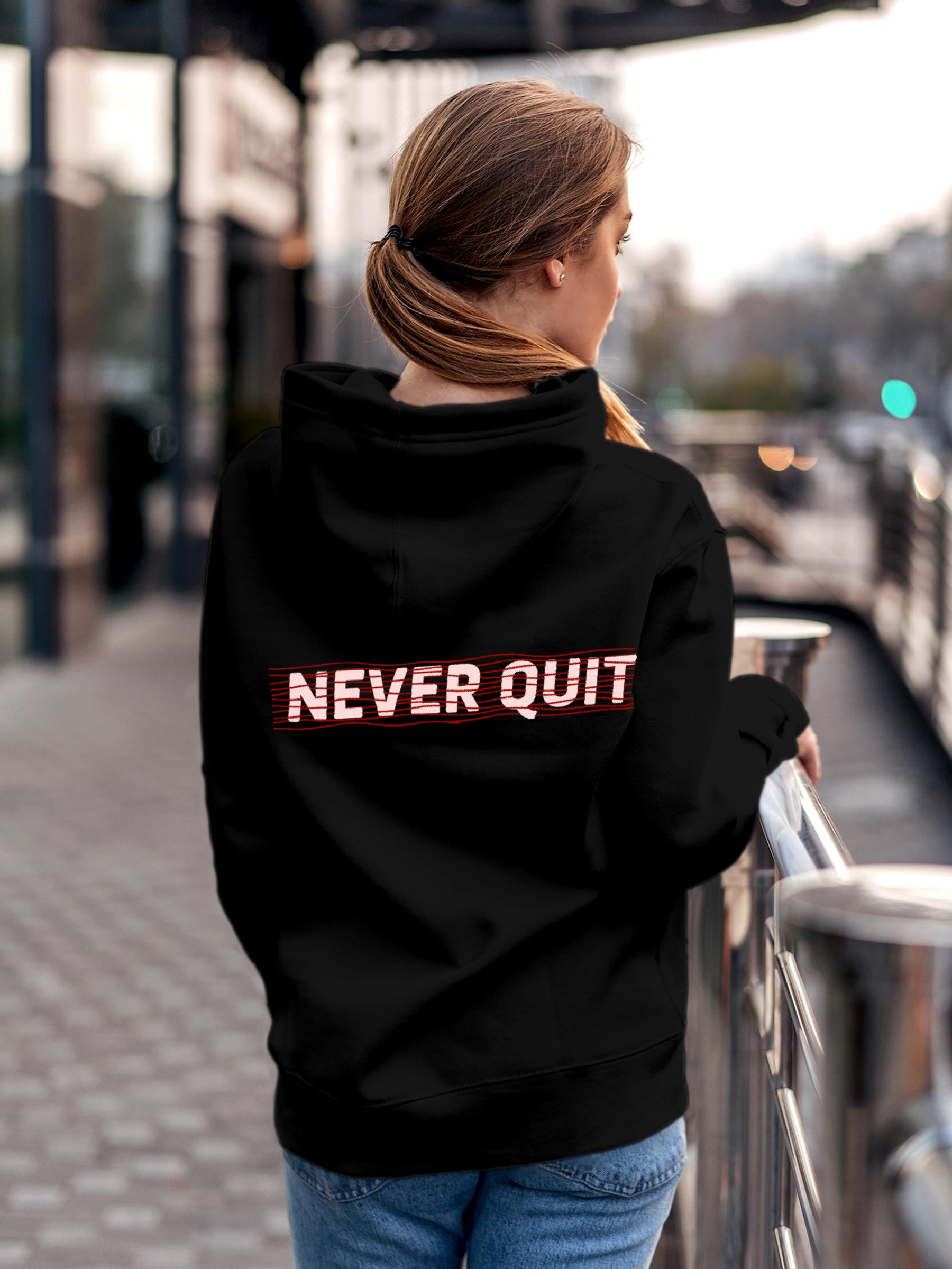 Model wearing Women's Black Hoodie Sweatshirt with 'Never Quit' design, offering effortless style and premium comfort