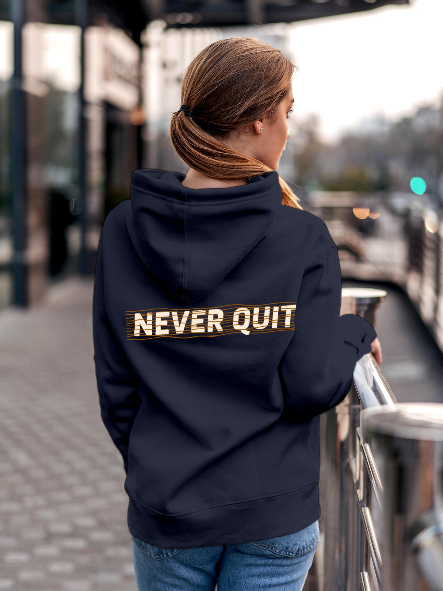 Model wearing Women's Navy Blue Hoodie Sweatshirt with 'Never Quit' design, offering effortless style and premium comfort