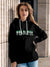 Model wearing Women's Black Hoodie Sweatshirt with 'Fearless' design, offering effortless style and premium comfort