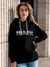 Model wearing Women's Black Hoodie Sweatshirt with 'Fearless' design, offering effortless style and premium comfort