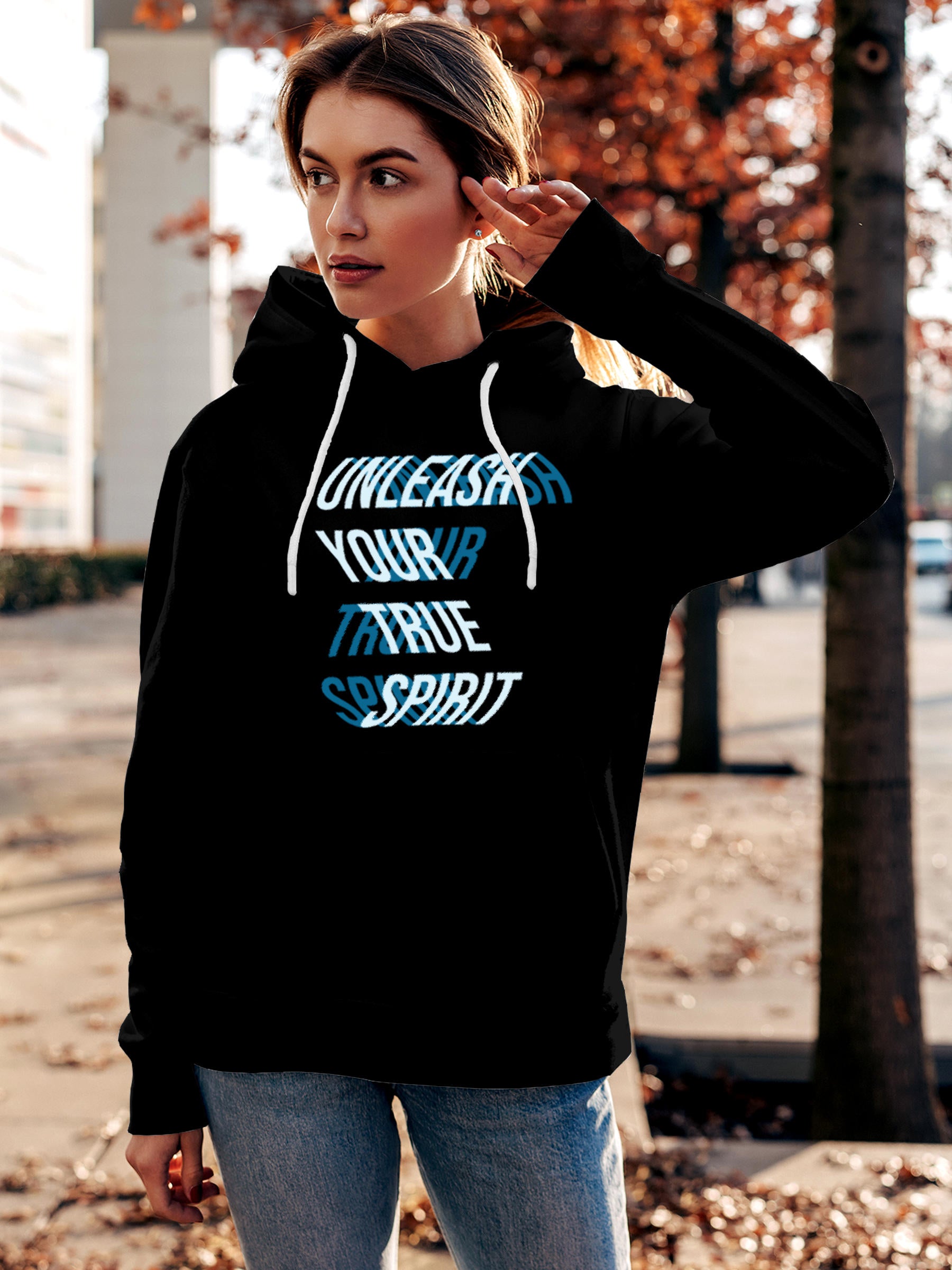 Model wearing Women's Black Hoodie Sweatshirt with 'Unleash Your True Spirit' design, offering effortless style and premium comfort