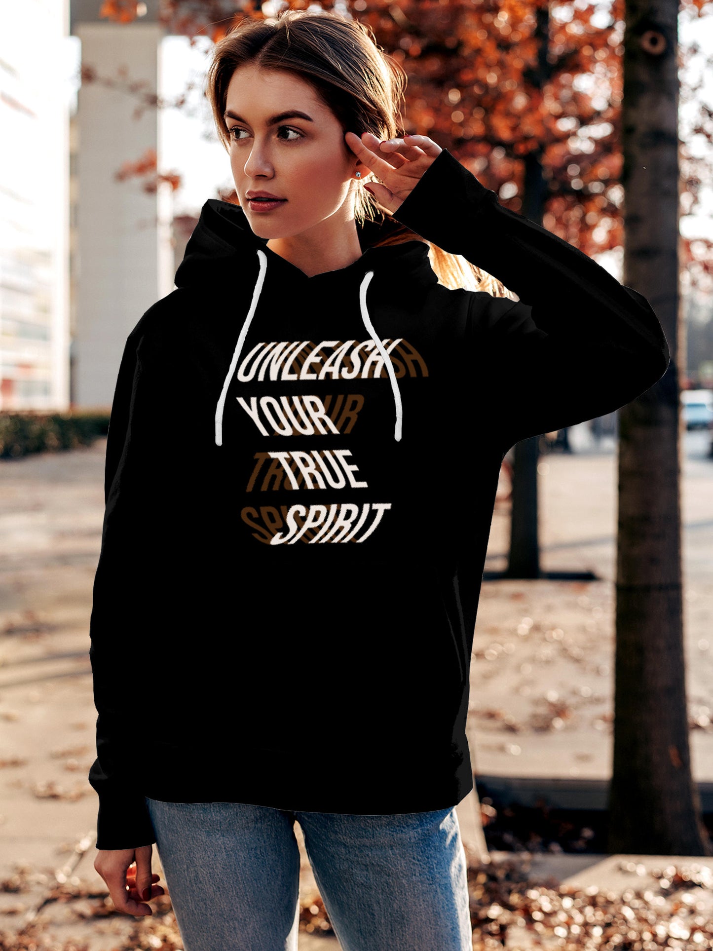 Model wearing Women's Black Hoodie Sweatshirt with 'Unleash Your True Spirit' design, offering effortless style and premium comfort