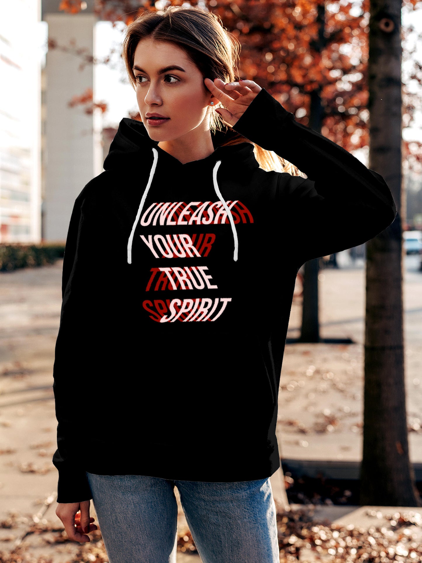 Model wearing Women's Black Hoodie Sweatshirt with 'Unleash Your True Spirit' design, offering effortless style and premium comfort