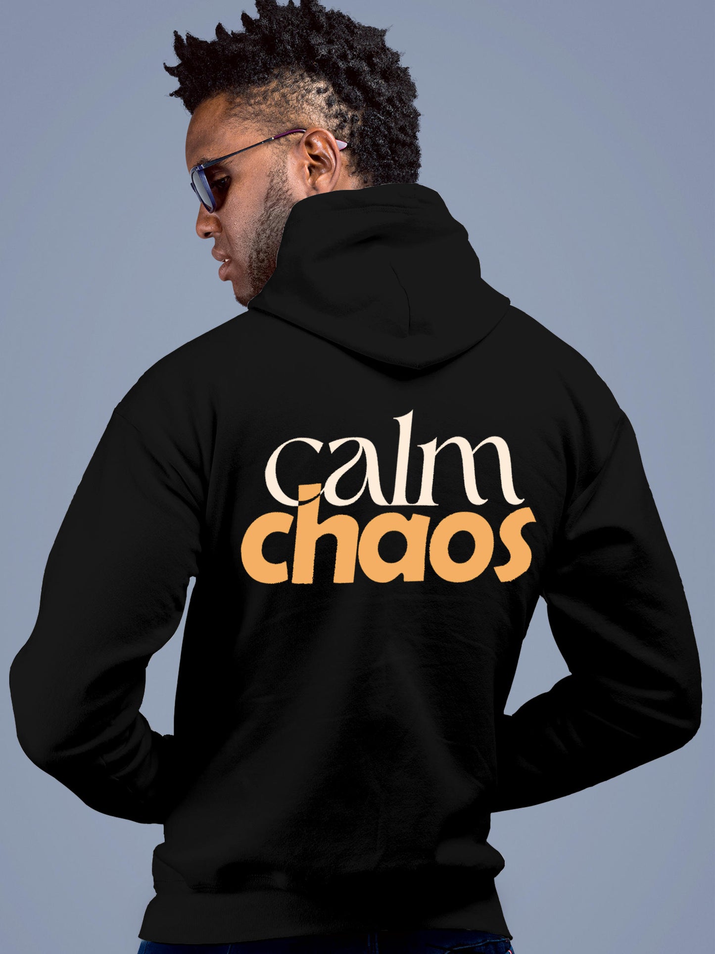 Model wearing Men's Black Hoodie Sweatshirt with 'Calm Chaos' design, offering effortless style and premium comfort