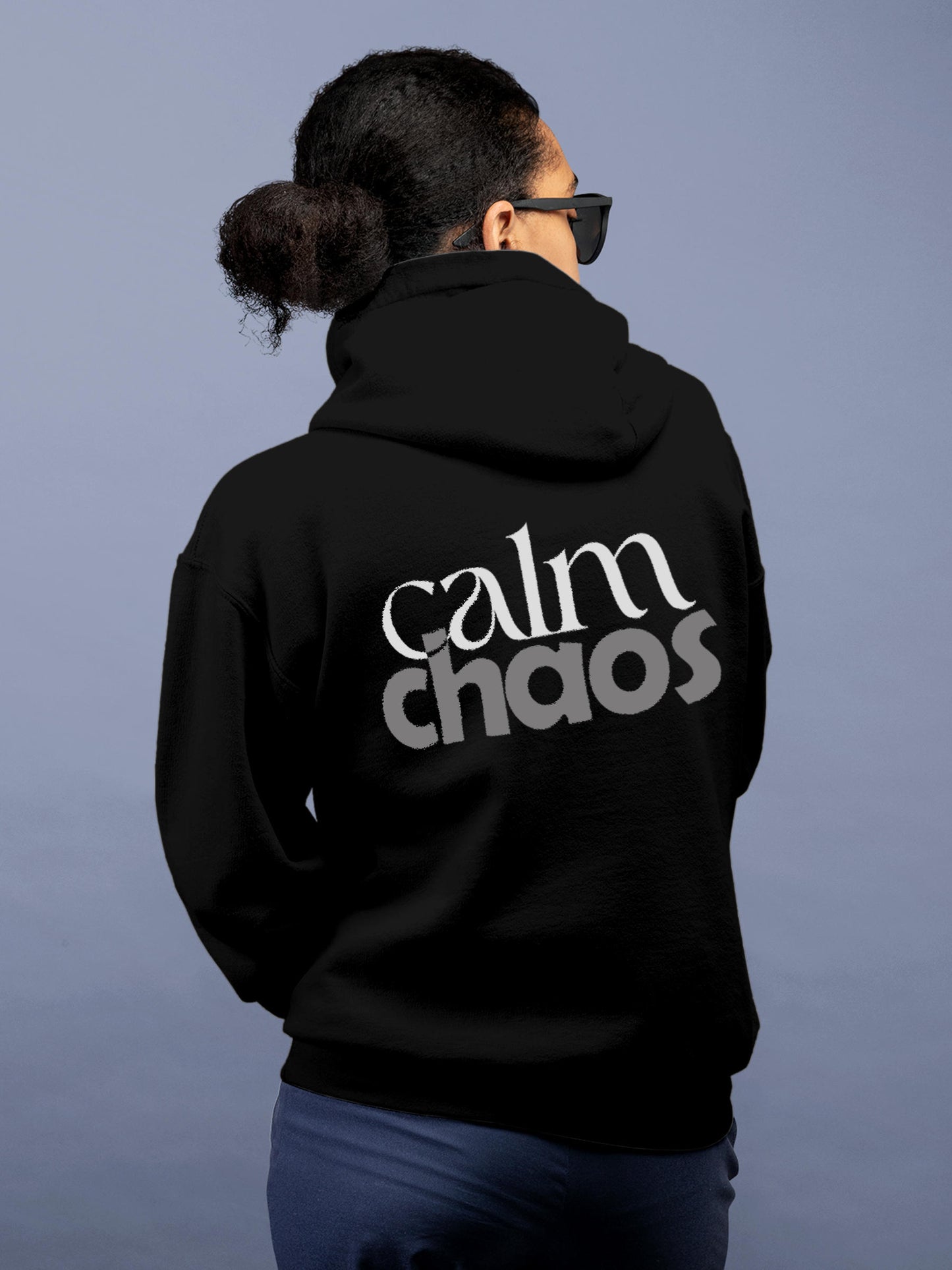 Model wearing Women's Black Hoodie Sweatshirt with 'Calm Chaos' design, offering effortless style and premium comfort