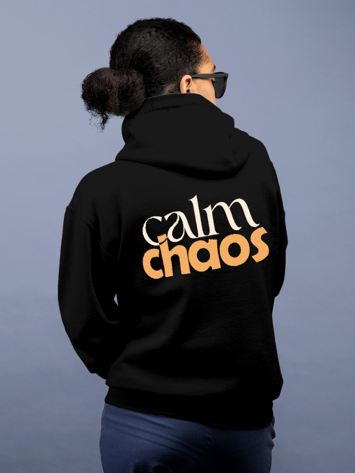 Model wearing Women's Black Hoodie Sweatshirt with 'Calm Chaos' design, offering effortless style and premium comfort