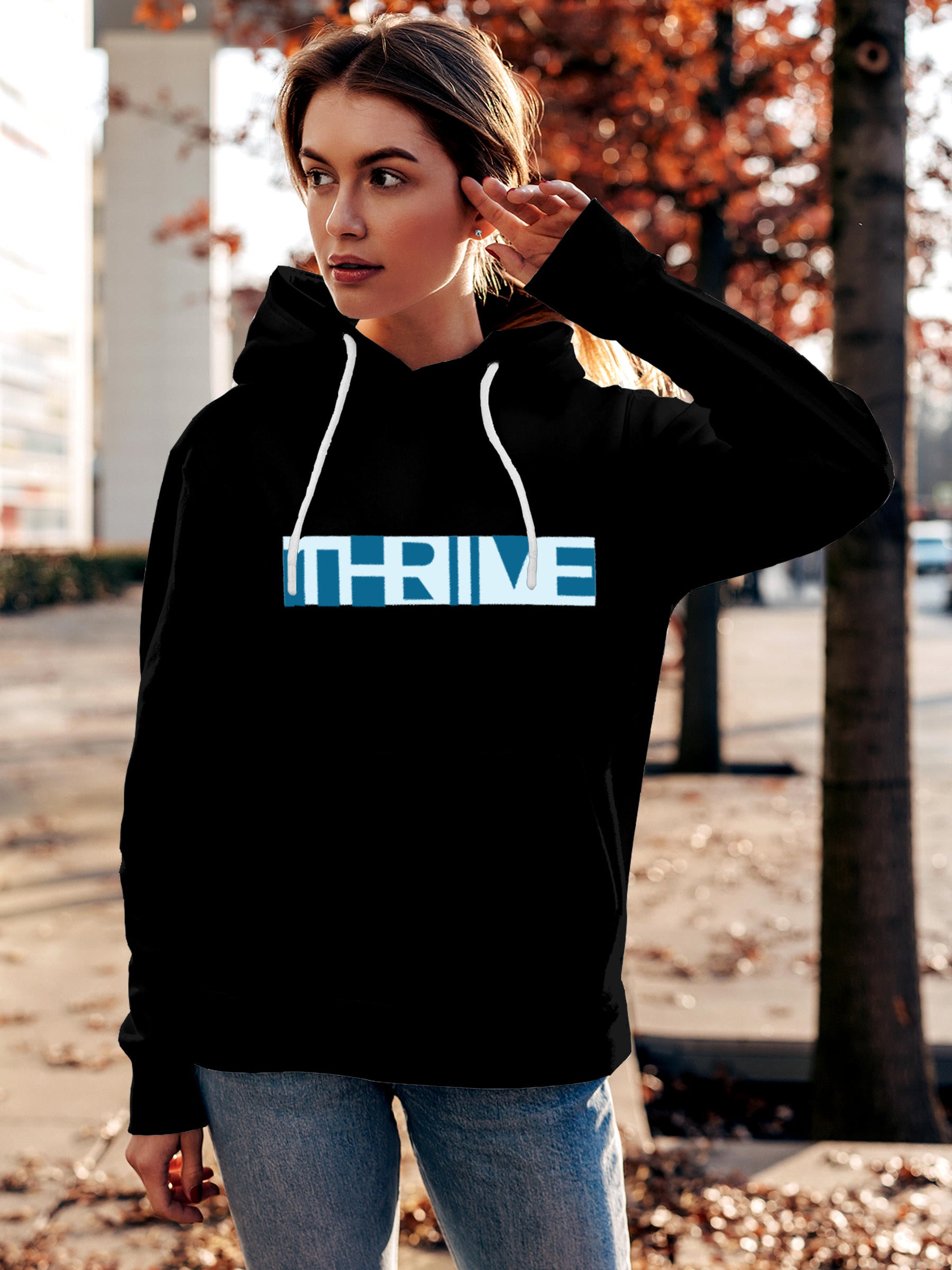Model wearing Women's Black Hoodie Sweatshirt with 'Thrive' design, offering effortless style and premium comfort