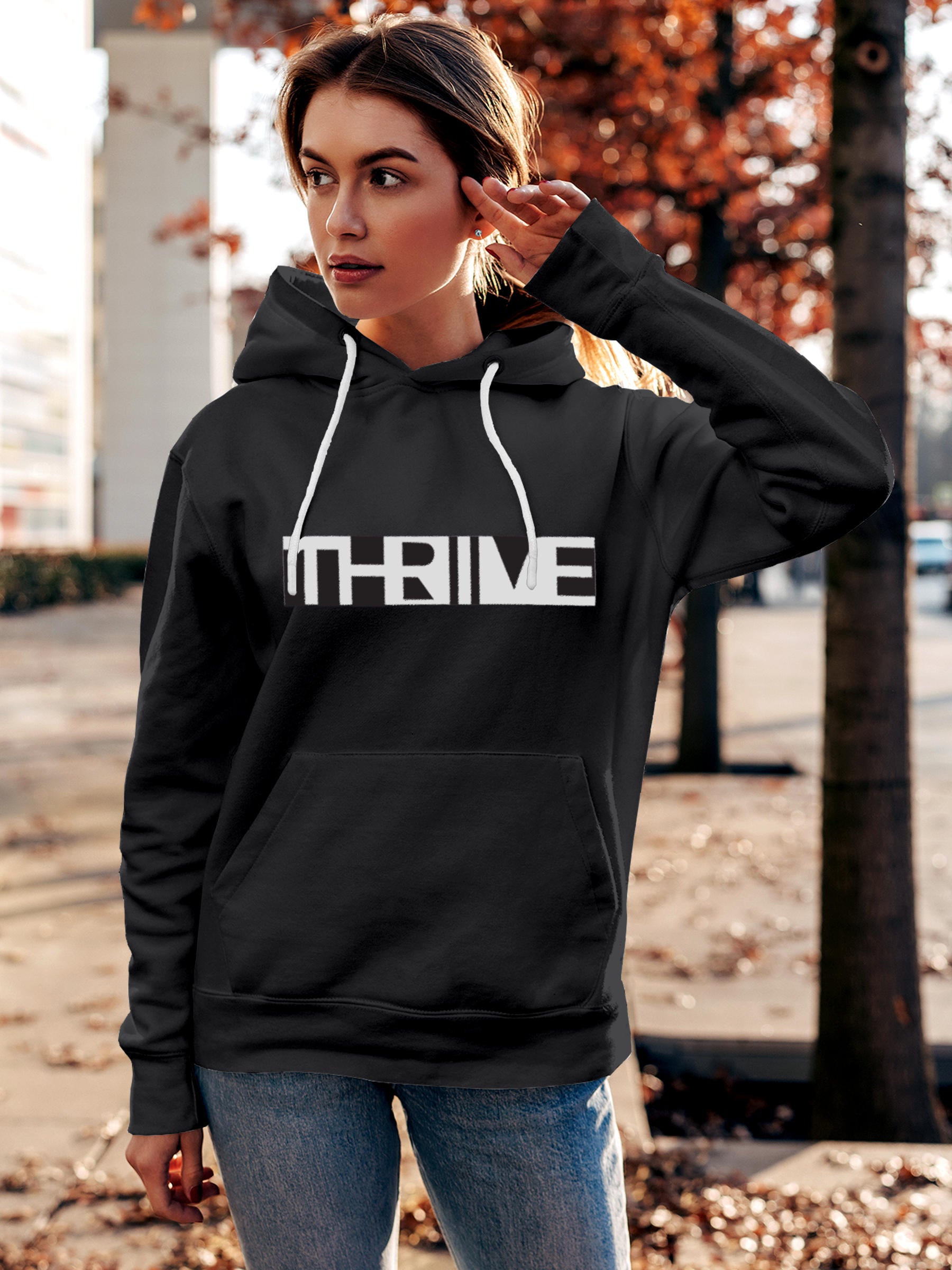 Model wearing Women's Dark Grey Hoodie Sweatshirt with 'Thrive' design, offering effortless style and premium comfort