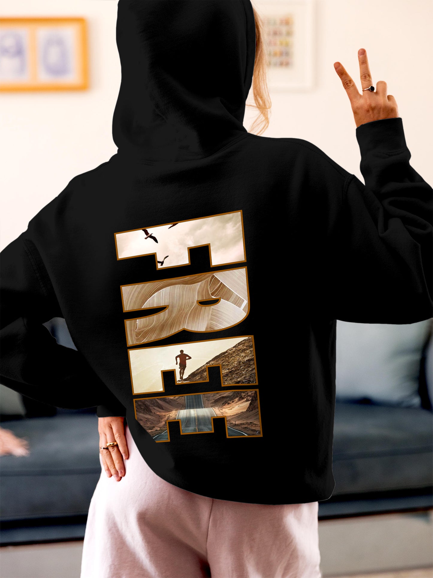 Model wearing Women's Black Hoodie Sweatshirt with 'Free & Boundless' design, offering effortless style and premium comfort