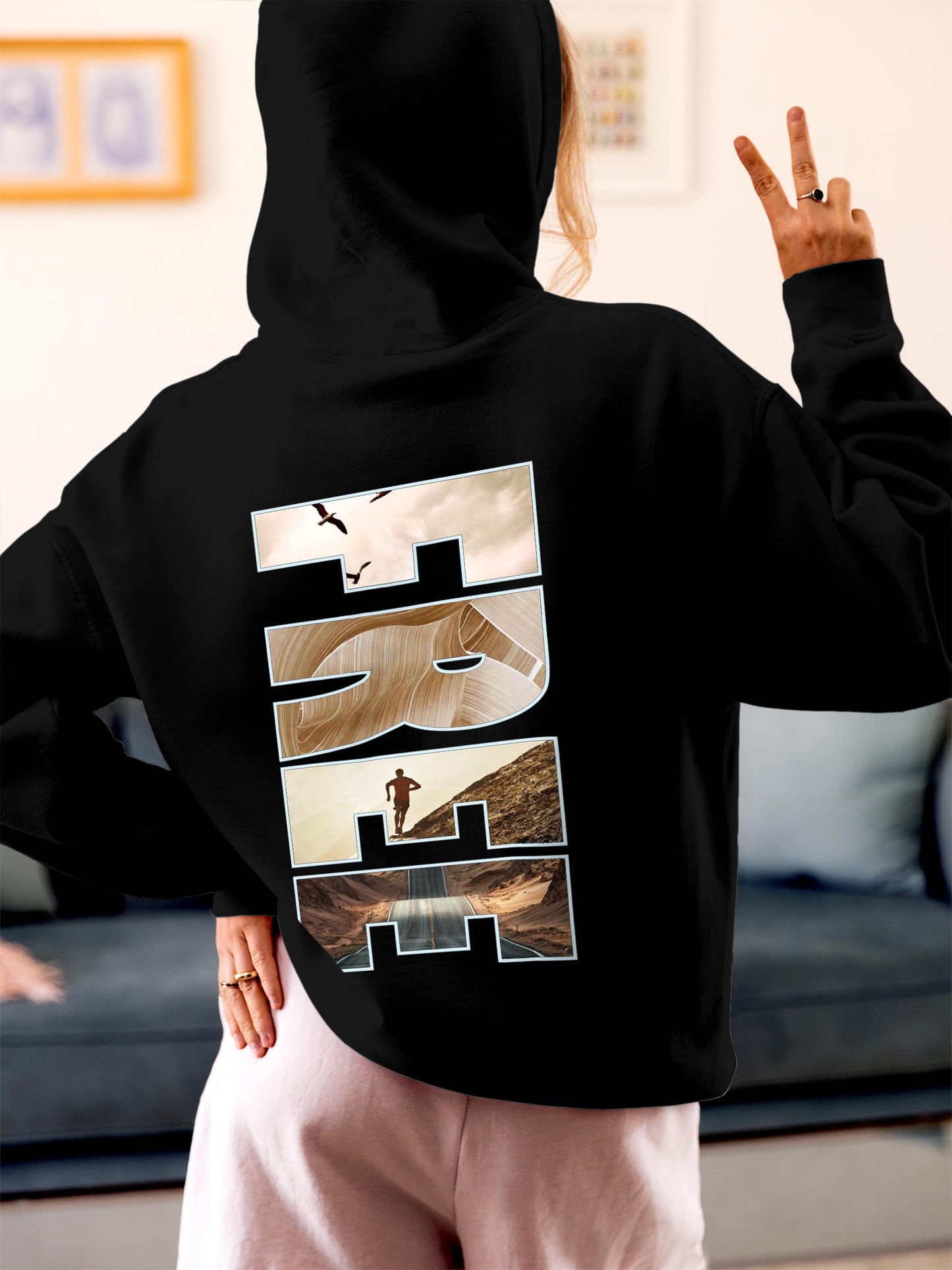 Model wearing Women's Black Hoodie Sweatshirt with 'Free & Boundless' design, offering effortless style and premium comfort