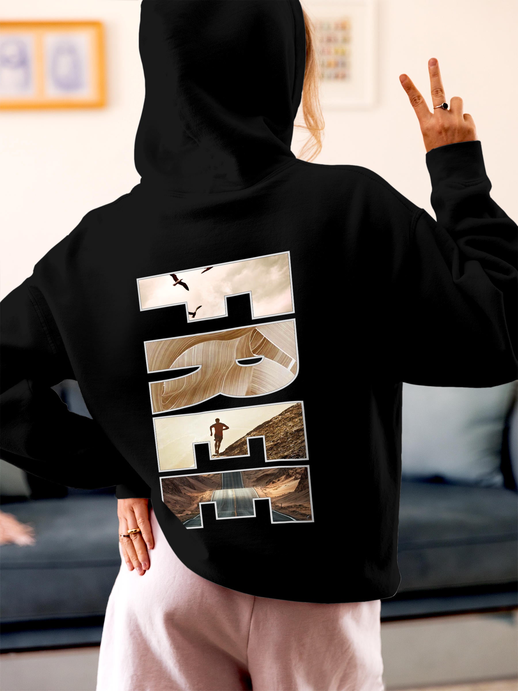Model wearing Women's Black Hoodie Sweatshirt with 'Free & Boundless' design, offering effortless style and premium comfort