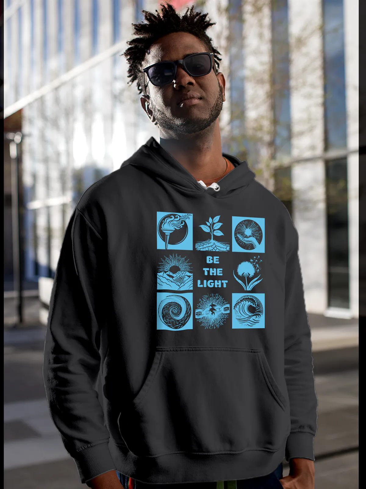 Model wearing Men's Dark Grey Hoodie Sweatshirt with 'Be The Light' design, offering effortless style and premium comfort