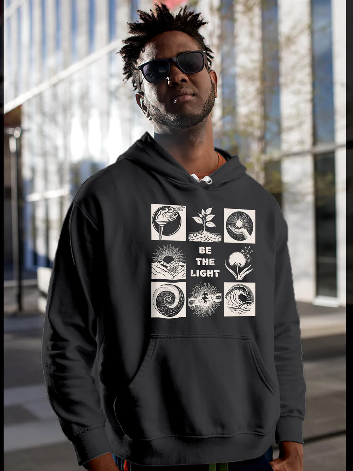 Model wearing Men's Dark Grey Hoodie Sweatshirt with 'Be The Light' design, offering effortless style and premium comfort