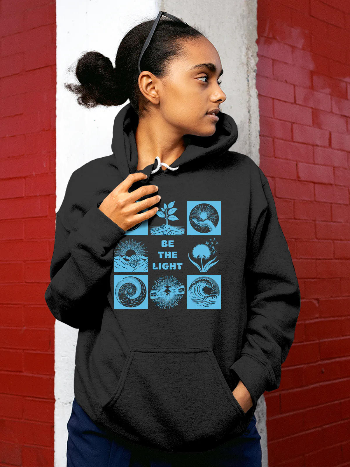 Model wearing Women's Dark Grey Hoodie Sweatshirt with 'Be The Light' design, offering effortless style and premium comfort