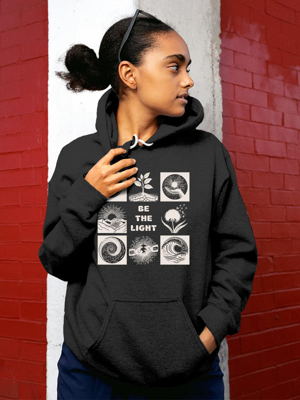 Model wearing Women's Dark Grey Hoodie Sweatshirt with 'Be The Light' design, offering effortless style and premium comfort