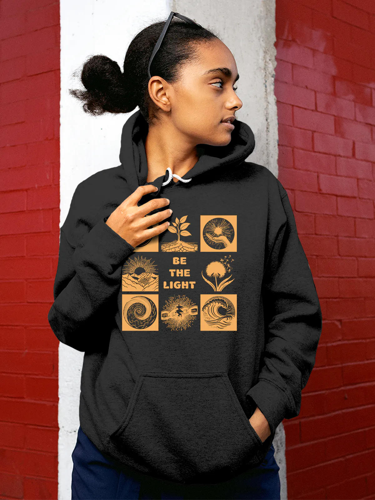 Model wearing Women's Dark Grey Hoodie Sweatshirt with 'Be The Light' design, offering effortless style and premium comfort