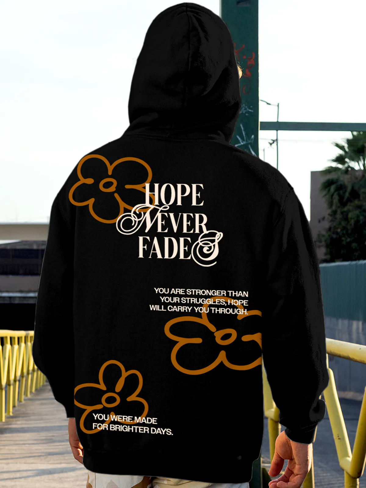 Model wearing Men's Black Hoodie Sweatshirt with 'Hope Never Fades' design, offering effortless style and premium comfort