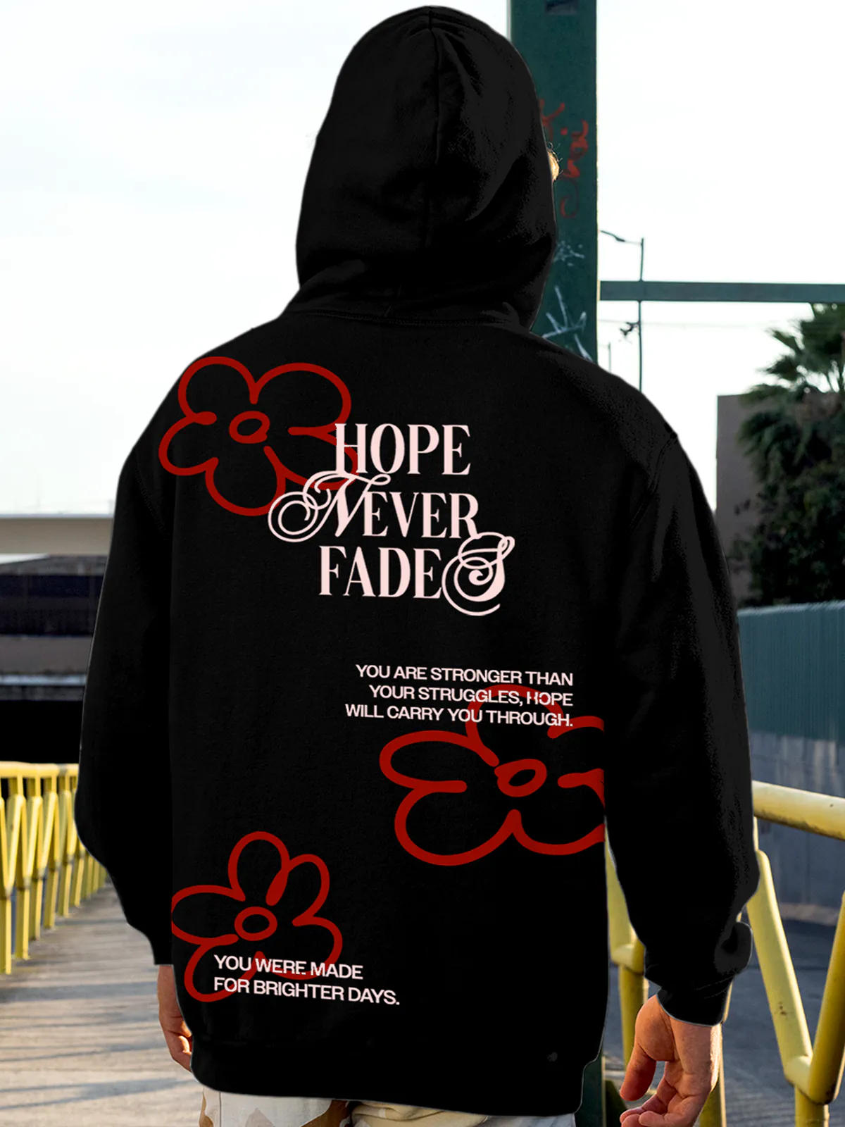 Model wearing Men's Black Hoodie Sweatshirt with 'Hope Never Fades' design, offering effortless style and premium comfort