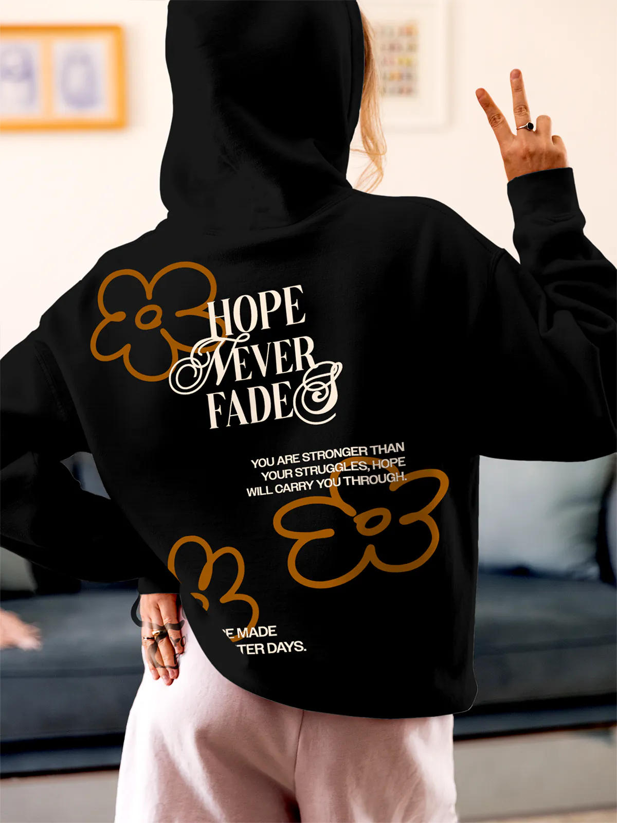 Model wearing Women's Black Hoodie Sweatshirt with 'Hope Never Fades' design, offering effortless style and premium comfort