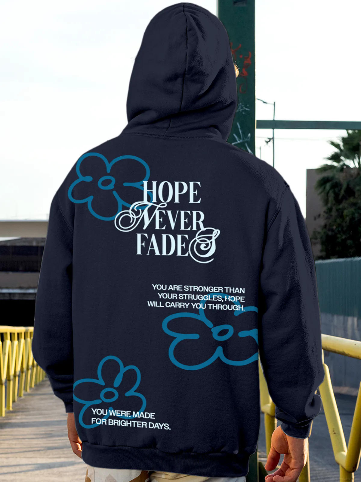 Model wearing Men's Navy Blue Hoodie Sweatshirt with 'Hope Never Fades' design, offering effortless style and premium comfort