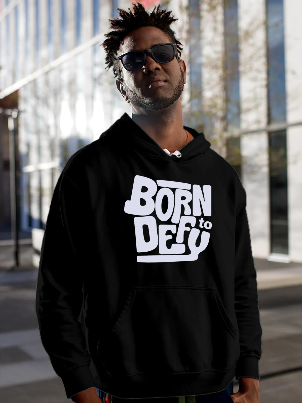 Model wearing Men's Black Hoodie Sweatshirt with 'Born To Defy' design, offering effortless style and premium comfort