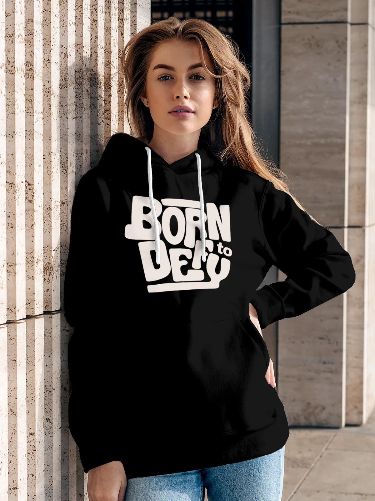 Model wearing Women's Black Hoodie Sweatshirt with 'Born To Defy' design, offering effortless style and premium comfort