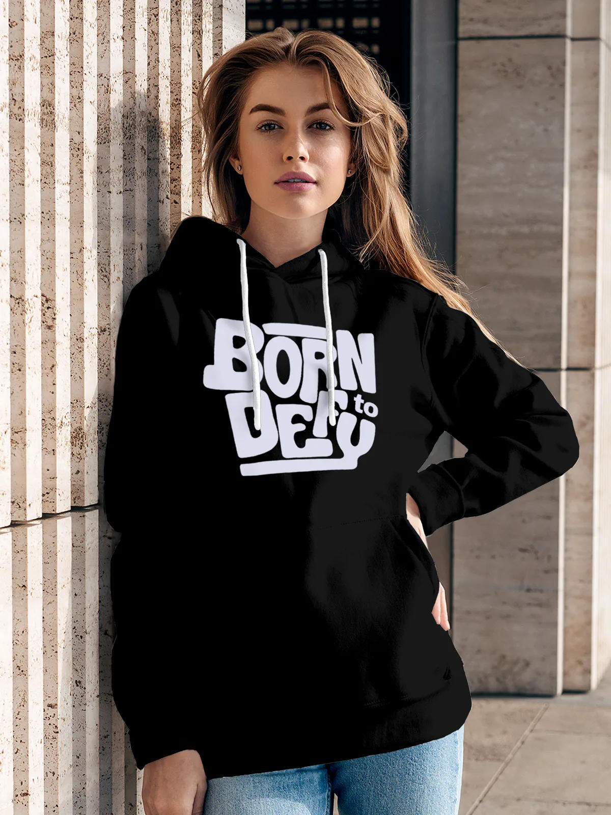 Model wearing Women's Black Hoodie Sweatshirt with 'Born To Defy' design, offering effortless style and premium comfort