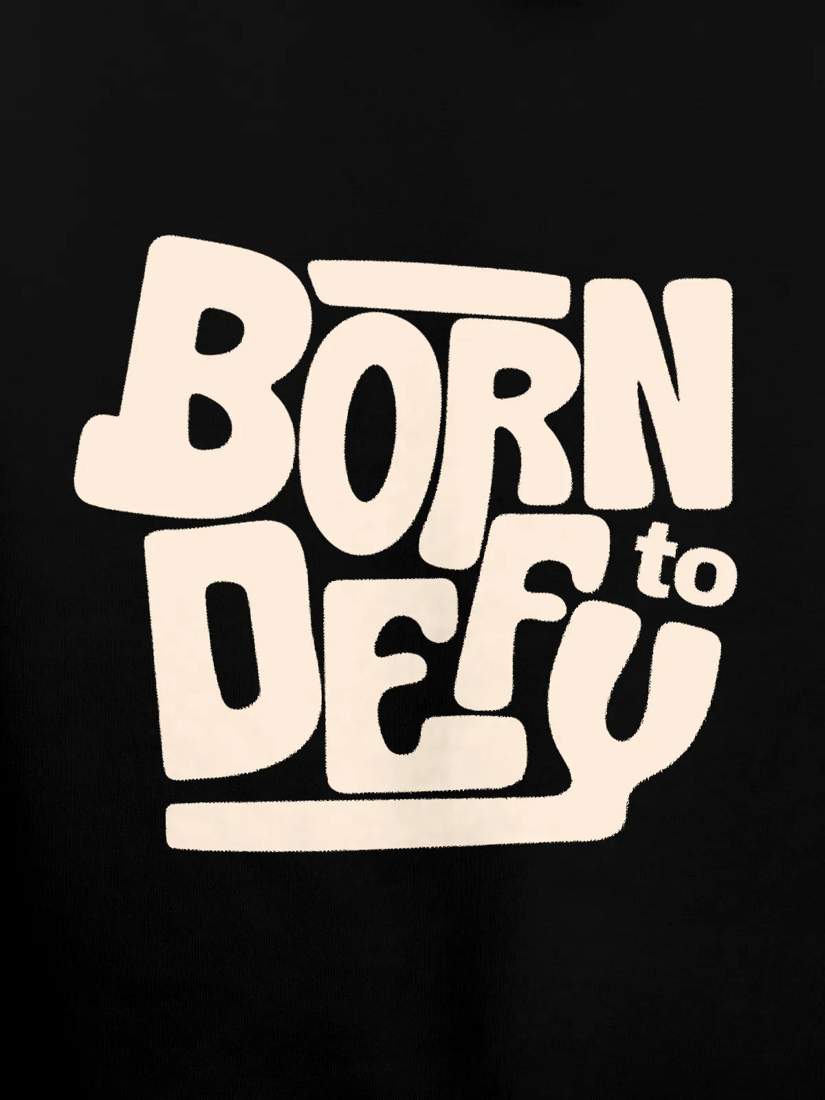 Close up of 'Born To Defy' design on Women's Black Hoodie Sweatshirt, highlighting intricate details and vibrant print.