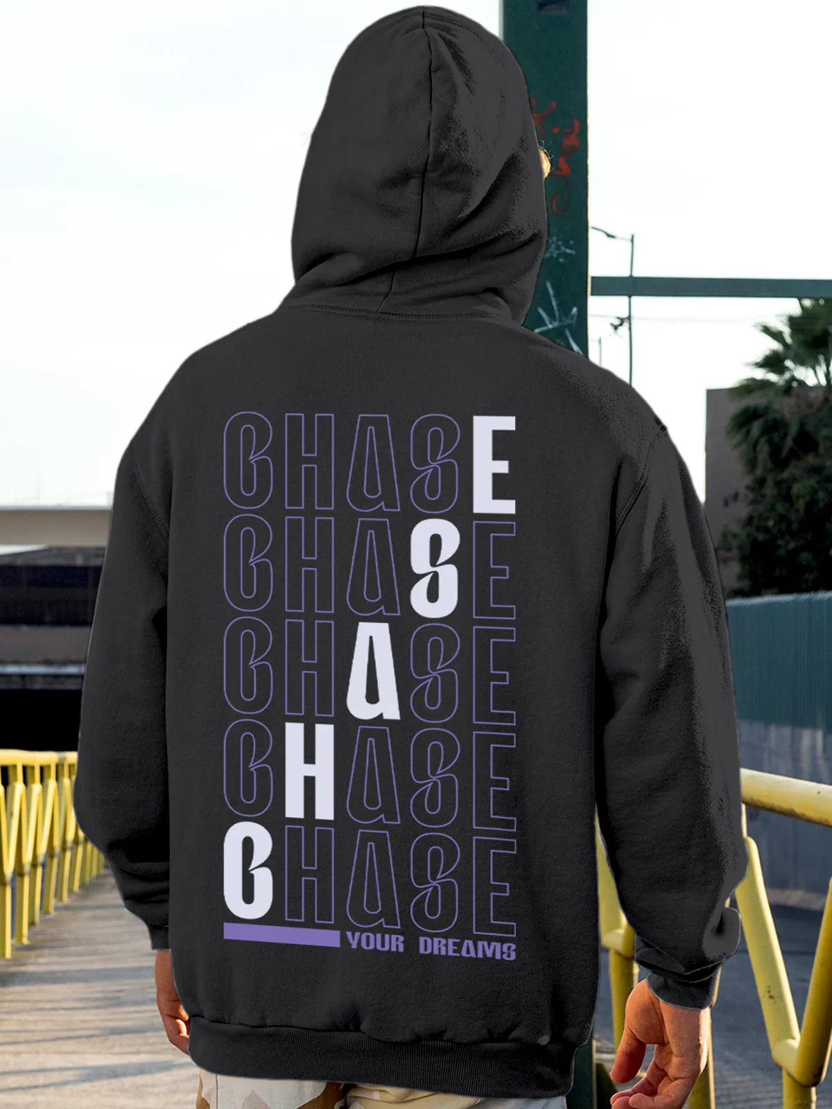 Model wearing Men's Dark Grey Hoodie Sweatshirt with 'Chase Your Dreams' design, offering effortless style and premium comfort