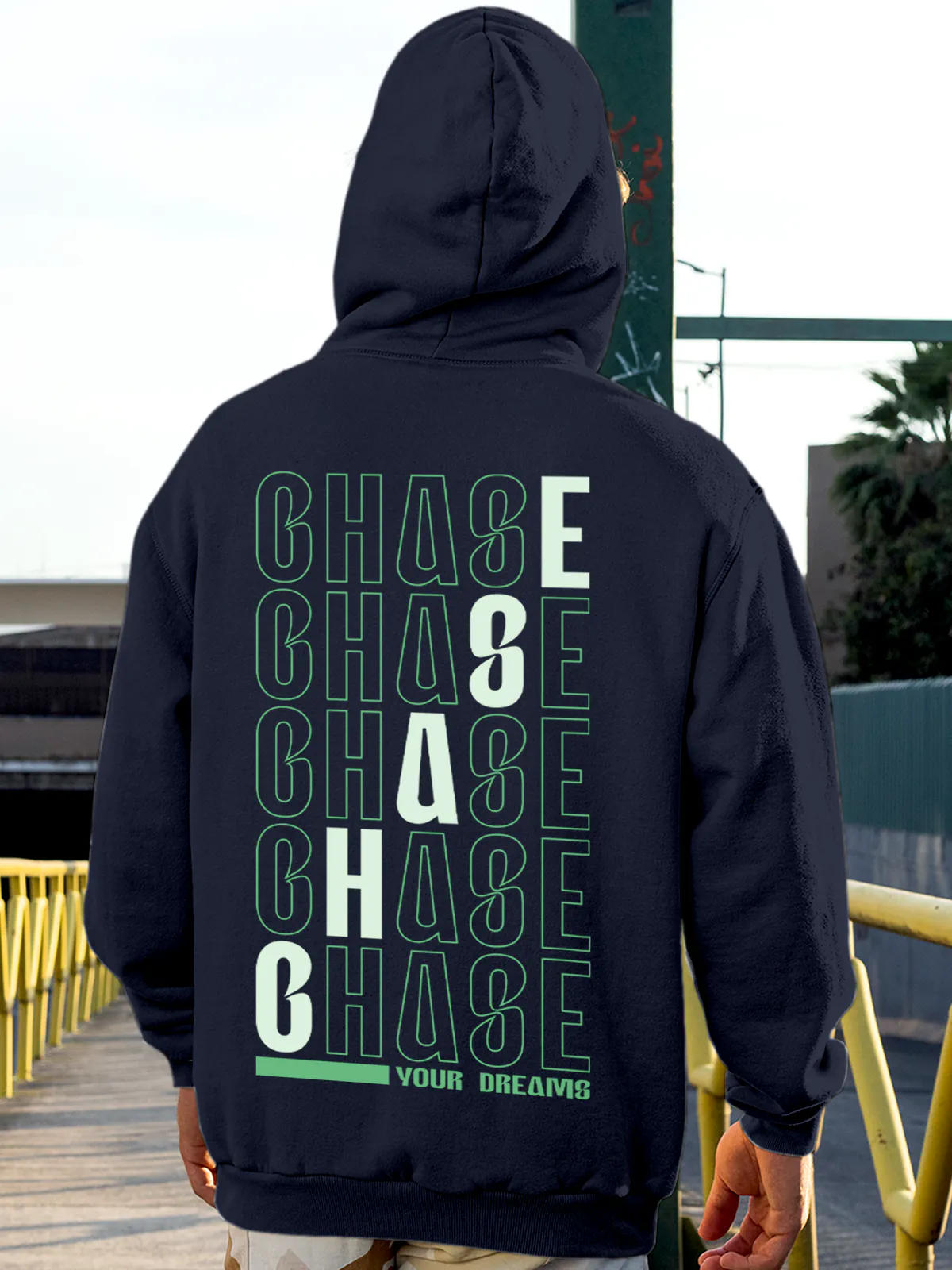 Model wearing Men's Navy Blue Hoodie Sweatshirt with 'Chase Your Dreams' design, offering effortless style and premium comfort