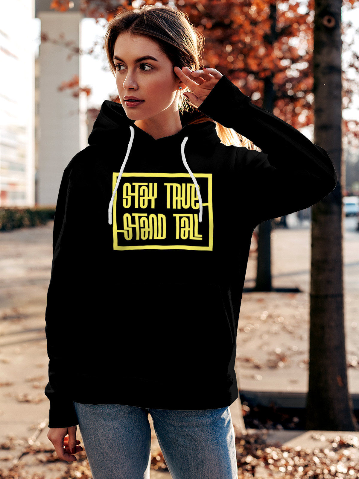 Model wearing Women's Black Hoodie Sweatshirt with 'Stay True Stand Tall' design, offering effortless style and premium comfort