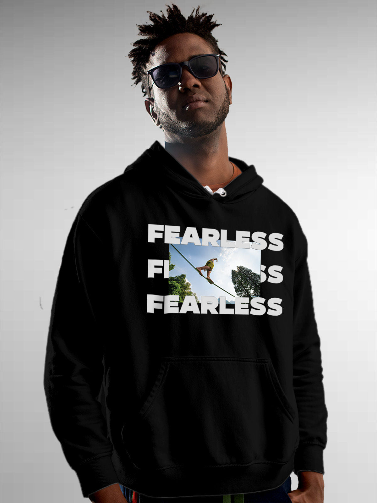 Model wearing Men's Black Hoodie Sweatshirt with 'Fearless' design, offering effortless style and premium comfort