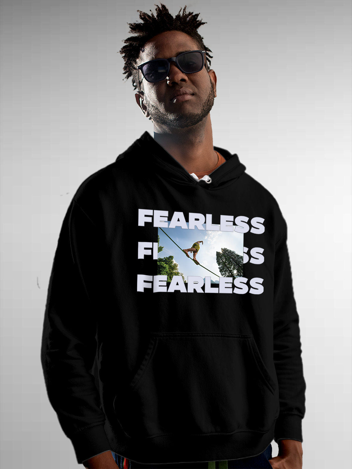 Model wearing Men's Black Hoodie Sweatshirt with 'Fearless' design, offering effortless style and premium comfort