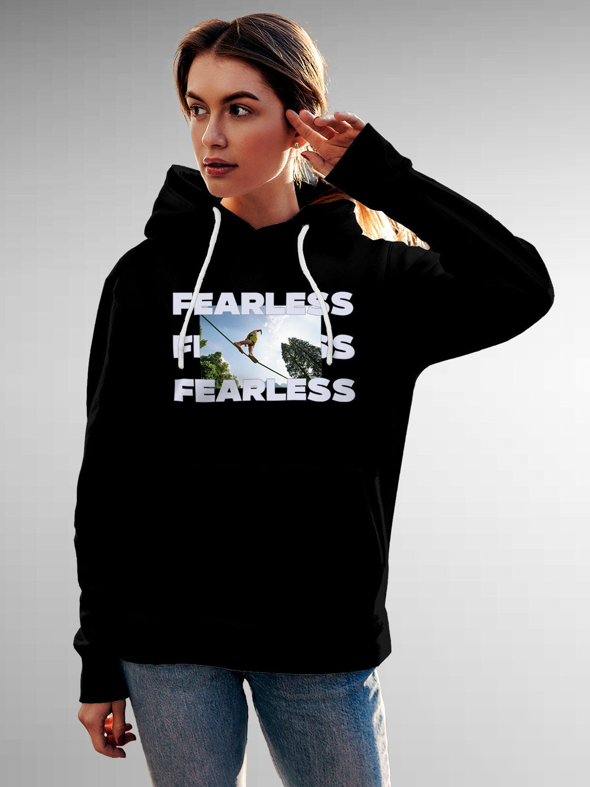 Model wearing Women's Black Hoodie Sweatshirt with 'Fearless' design, offering effortless style and premium comfort