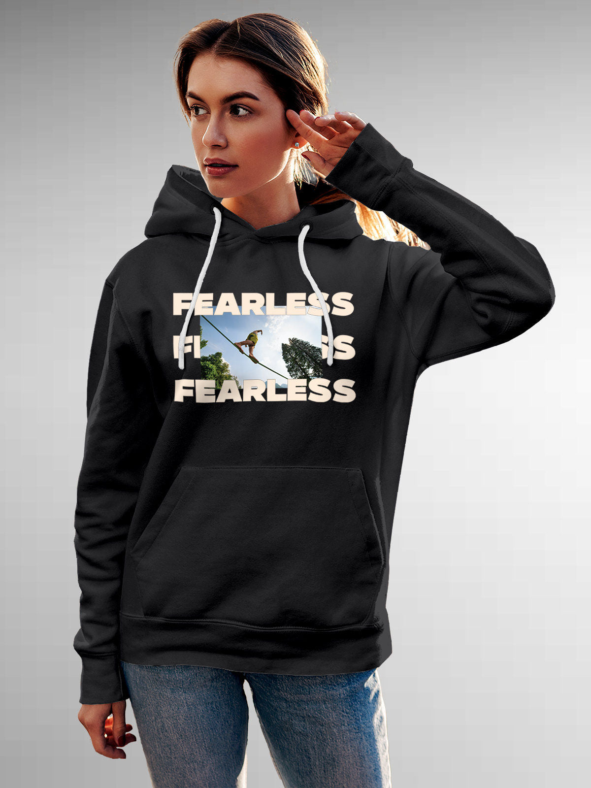Model wearing Women's Dark Grey Hoodie Sweatshirt with 'Fearless' design, offering effortless style and premium comfort