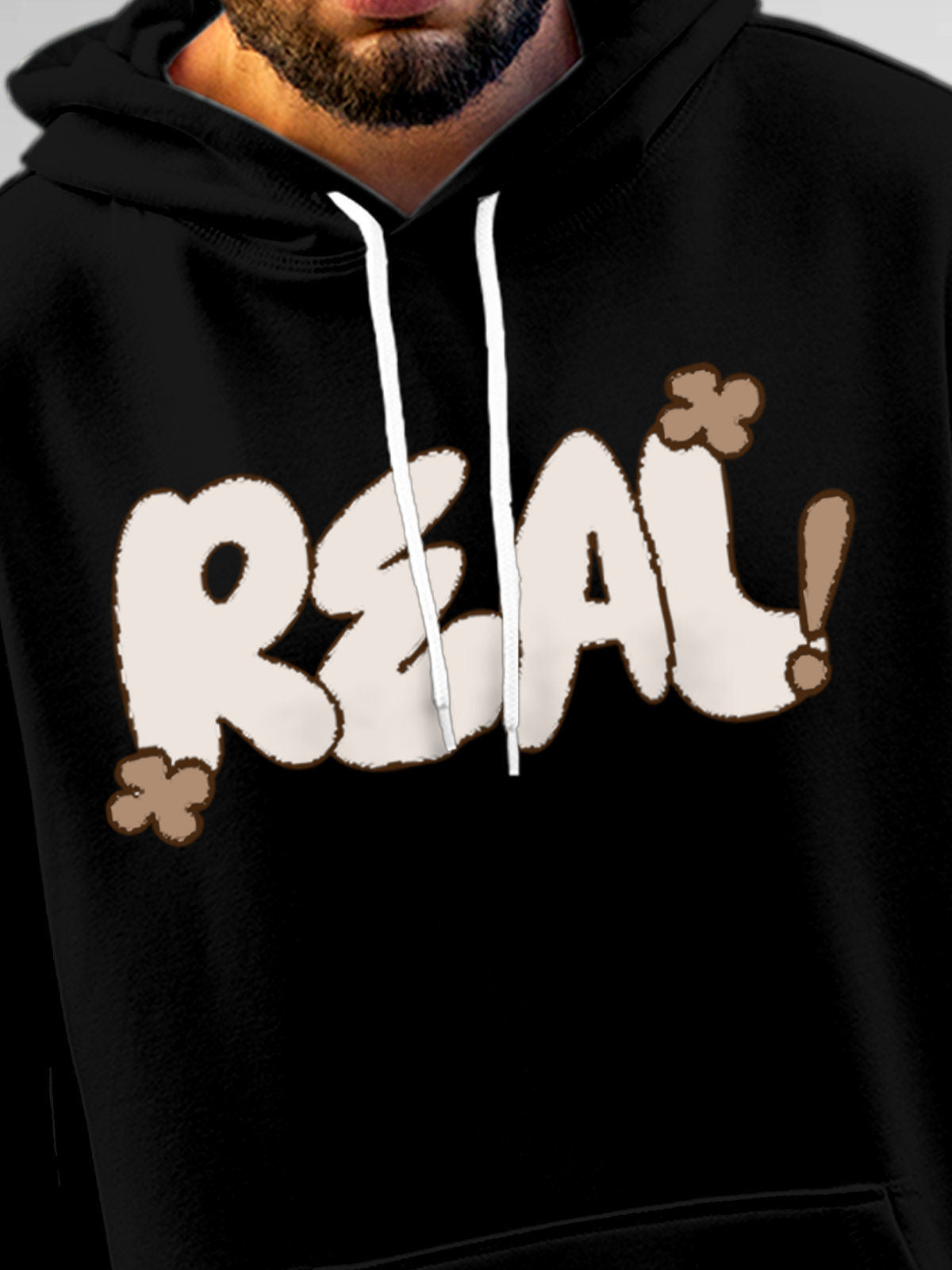 Close up of 'Real' design on Men's Black Hoodie Sweatshirt, highlighting intricate details and vibrant print.