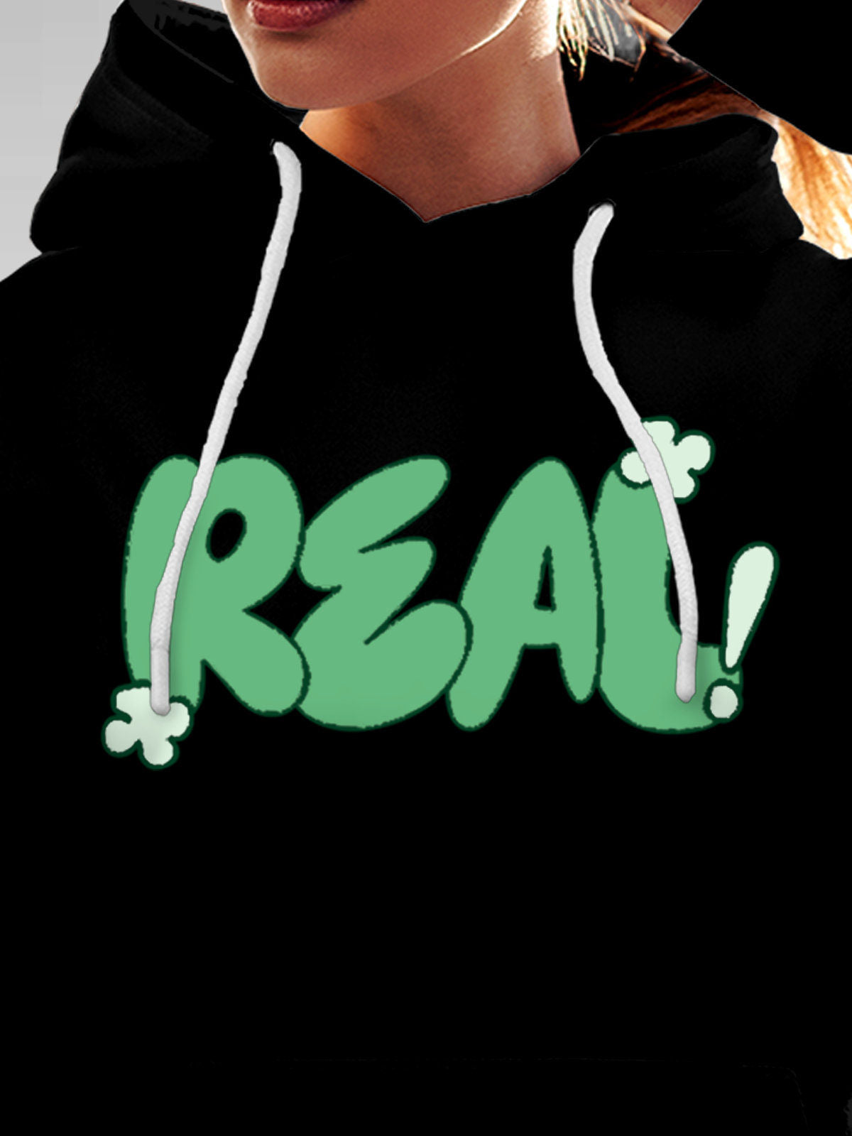 Close up of 'Real' design on Women's Black Hoodie Sweatshirt, highlighting intricate details and vibrant print.