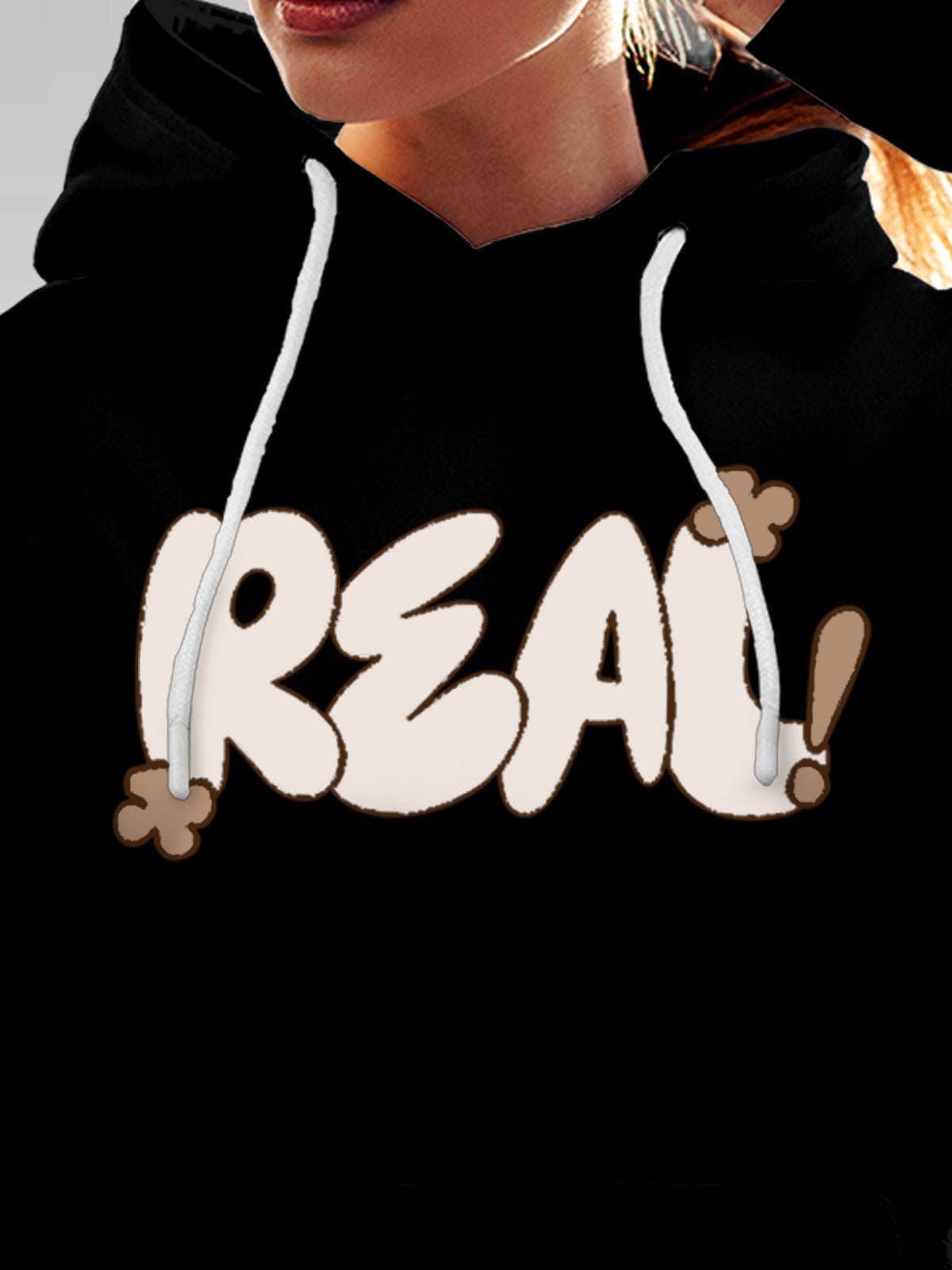Close up of 'Real' design on Women's Black Hoodie Sweatshirt, highlighting intricate details and vibrant print.