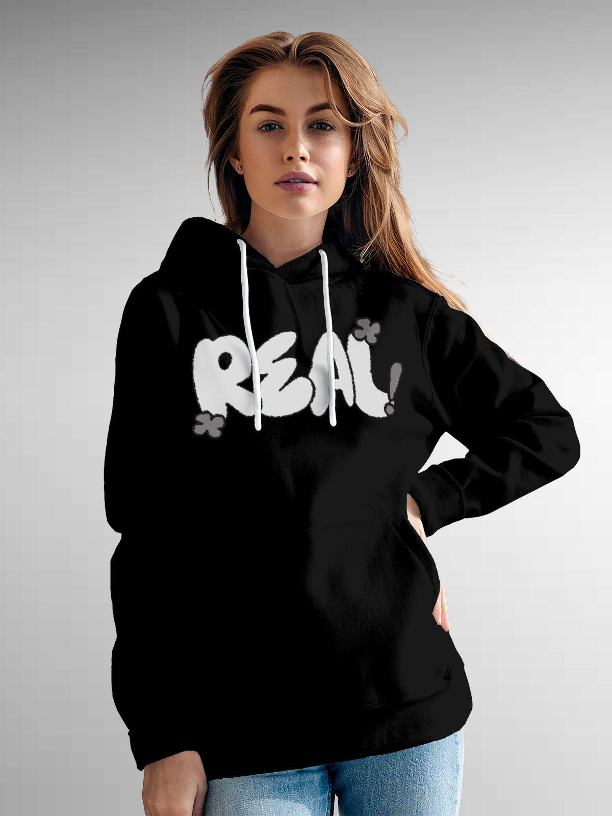 Model wearing Women's Black Hoodie Sweatshirt with 'Real' design, offering effortless style and premium comfort