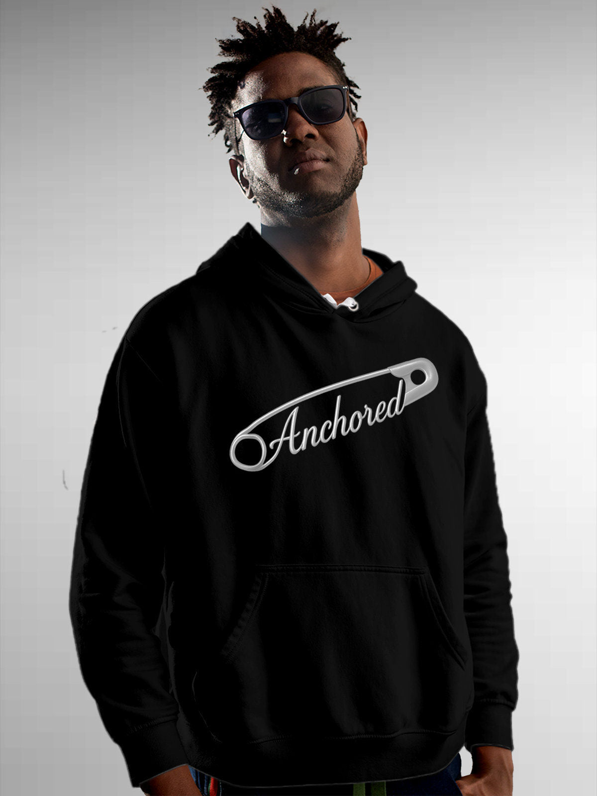 Model wearing Men's Black Hoodie Sweatshirt with 'Anchored' design, offering effortless style and premium comfort