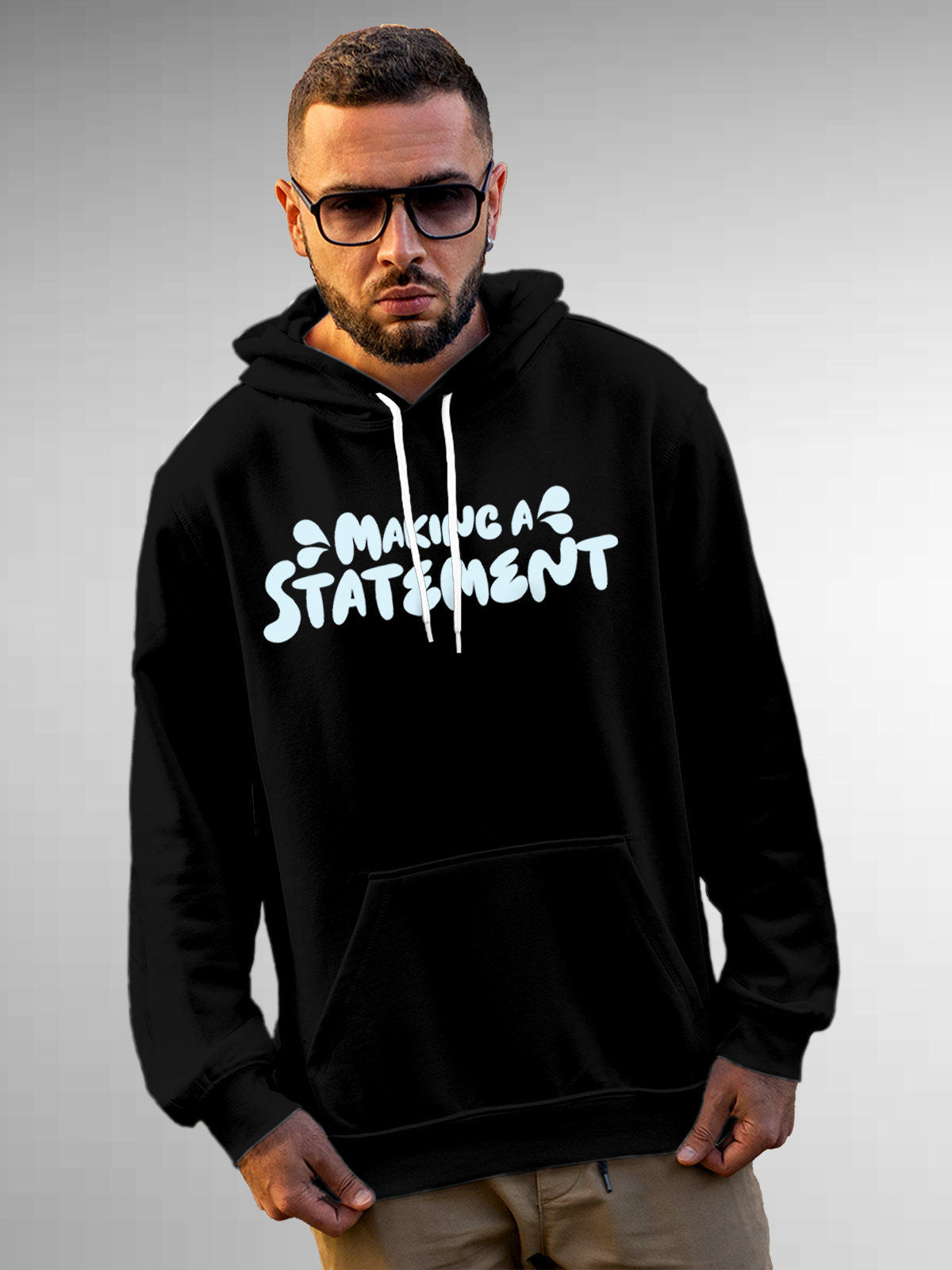 Model wearing Men's Black Hoodie Sweatshirt with 'Making A Statement' design, offering effortless style and premium comfort