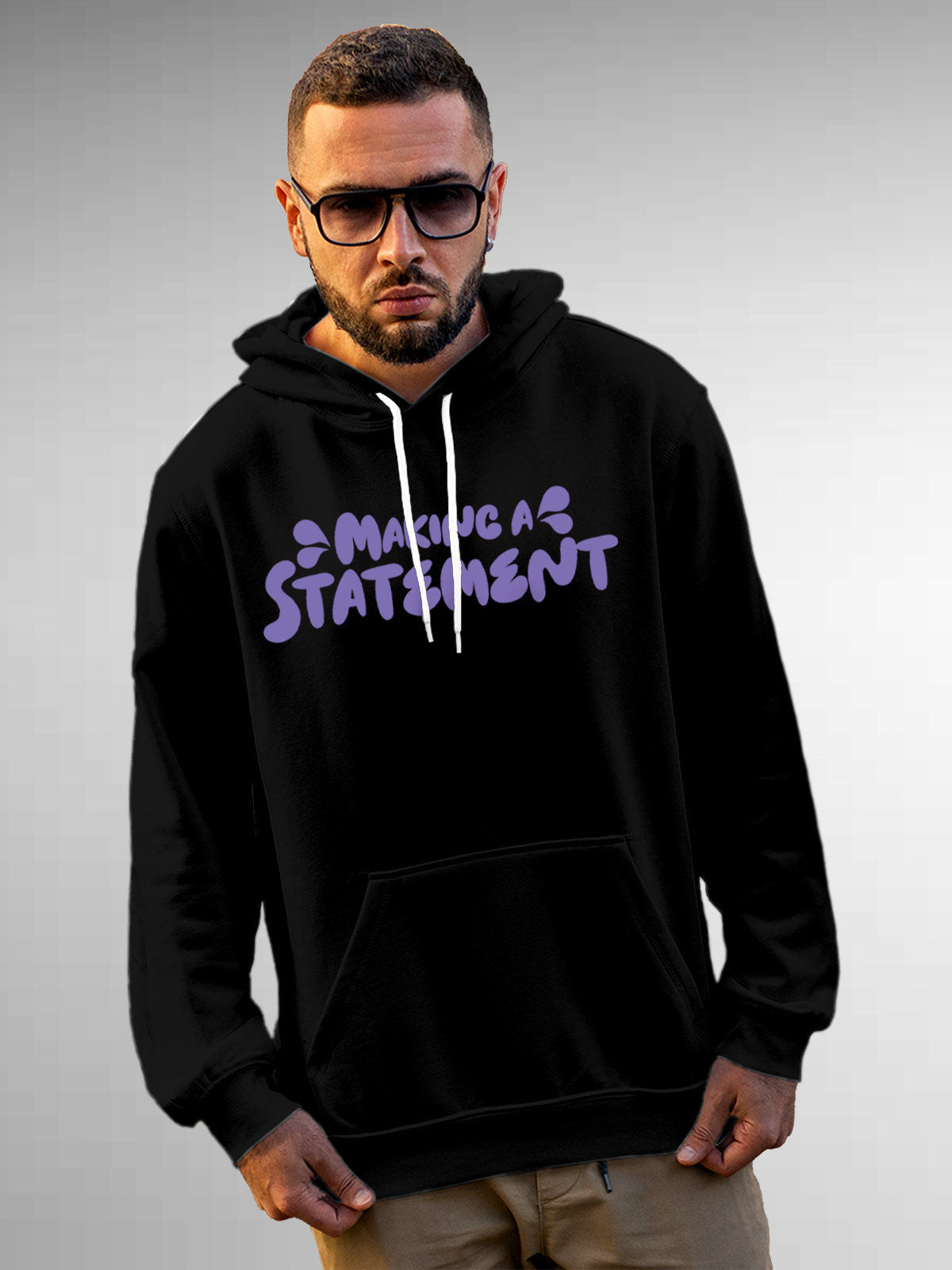 Model wearing Men's Black Hoodie Sweatshirt with 'Making A Statement' design, offering effortless style and premium comfort