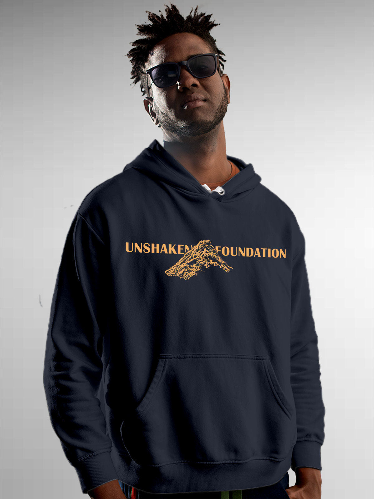 Model wearing Men's Navy Blue Hoodie Sweatshirt with 'Unshaken Foundation' design, offering effortless style and premium comfort