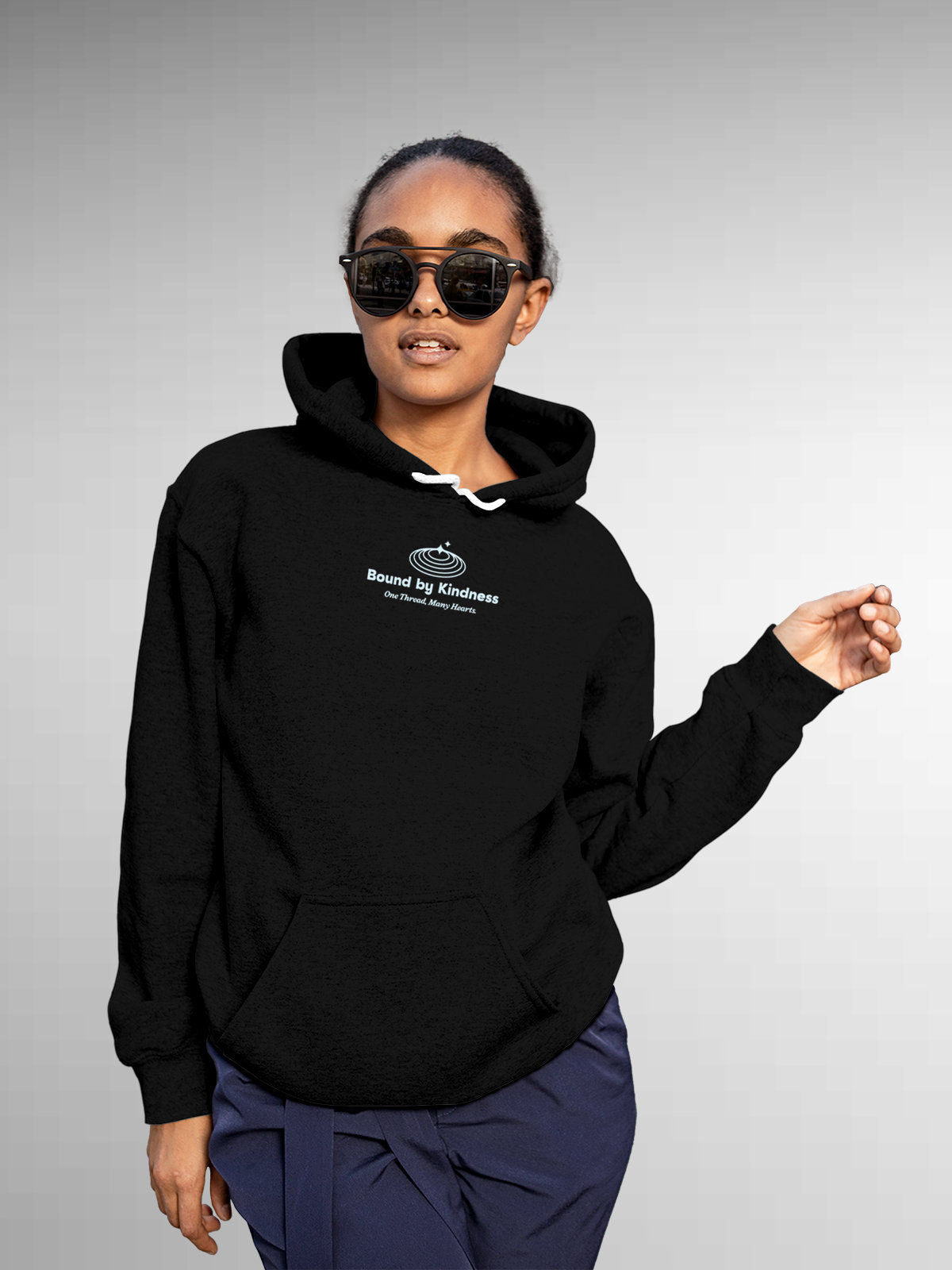 Model wearing Women's Black Hoodie Sweatshirt with 'Bound By Kindness' design, offering effortless style and premium comfort