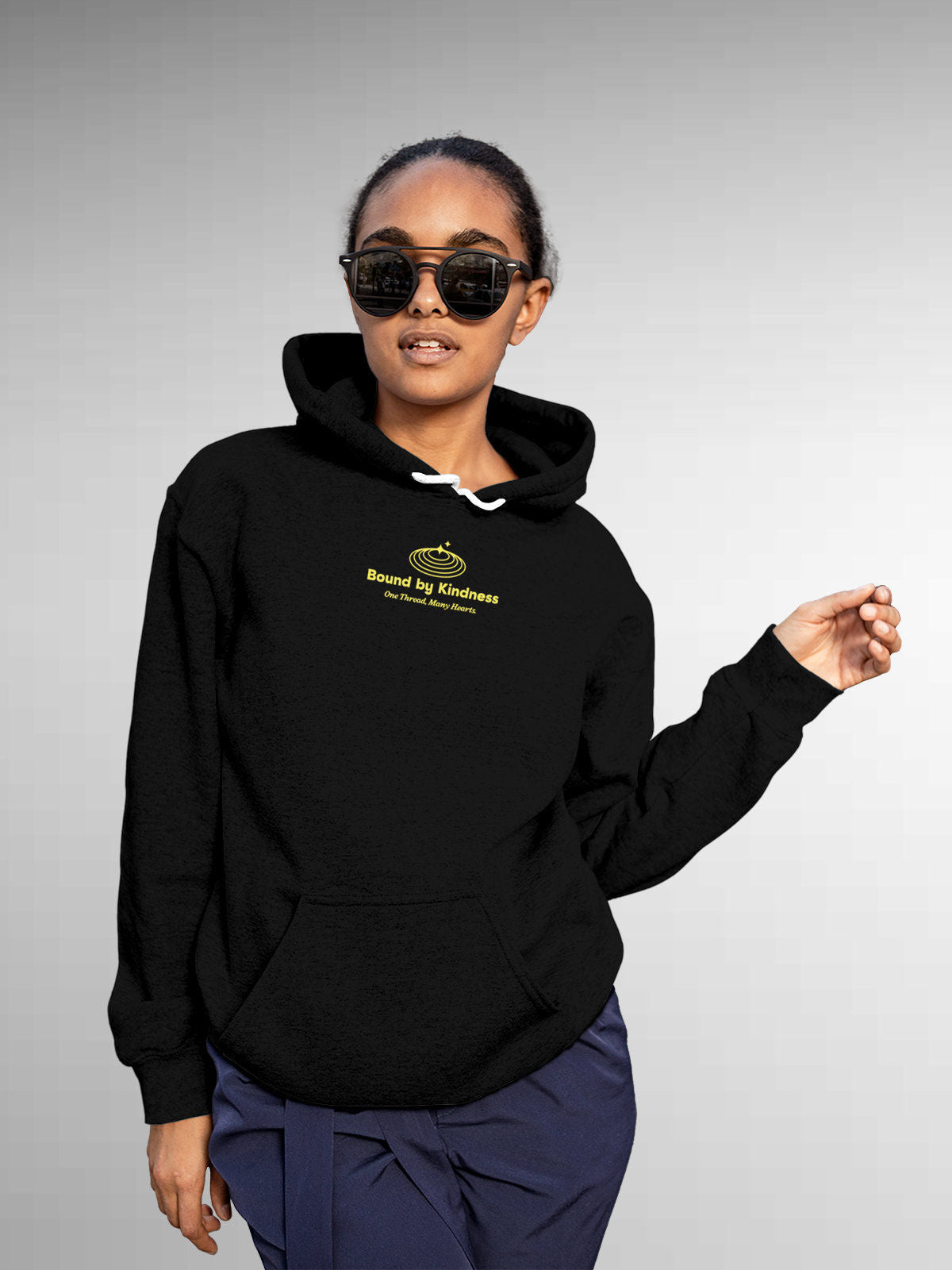 Model wearing Women's Black Hoodie Sweatshirt with 'Bound By Kindness' design, offering effortless style and premium comfort