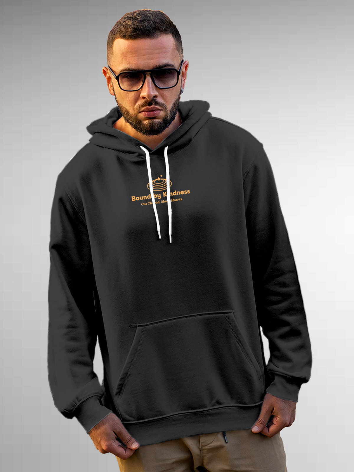 Model wearing Men's Dark Grey Hoodie Sweatshirt with 'Bound By Kindness' design, offering effortless style and premium comfort
