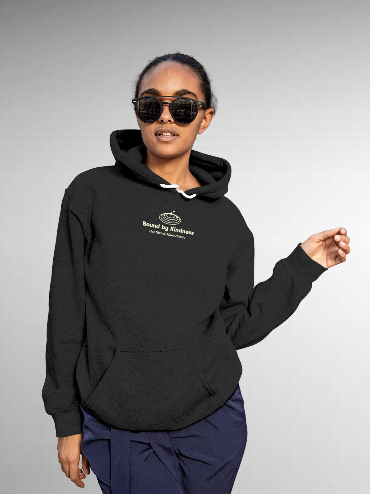 Model wearing Women's Dark Grey Hoodie Sweatshirt with 'Bound By Kindness' design, offering effortless style and premium comfort