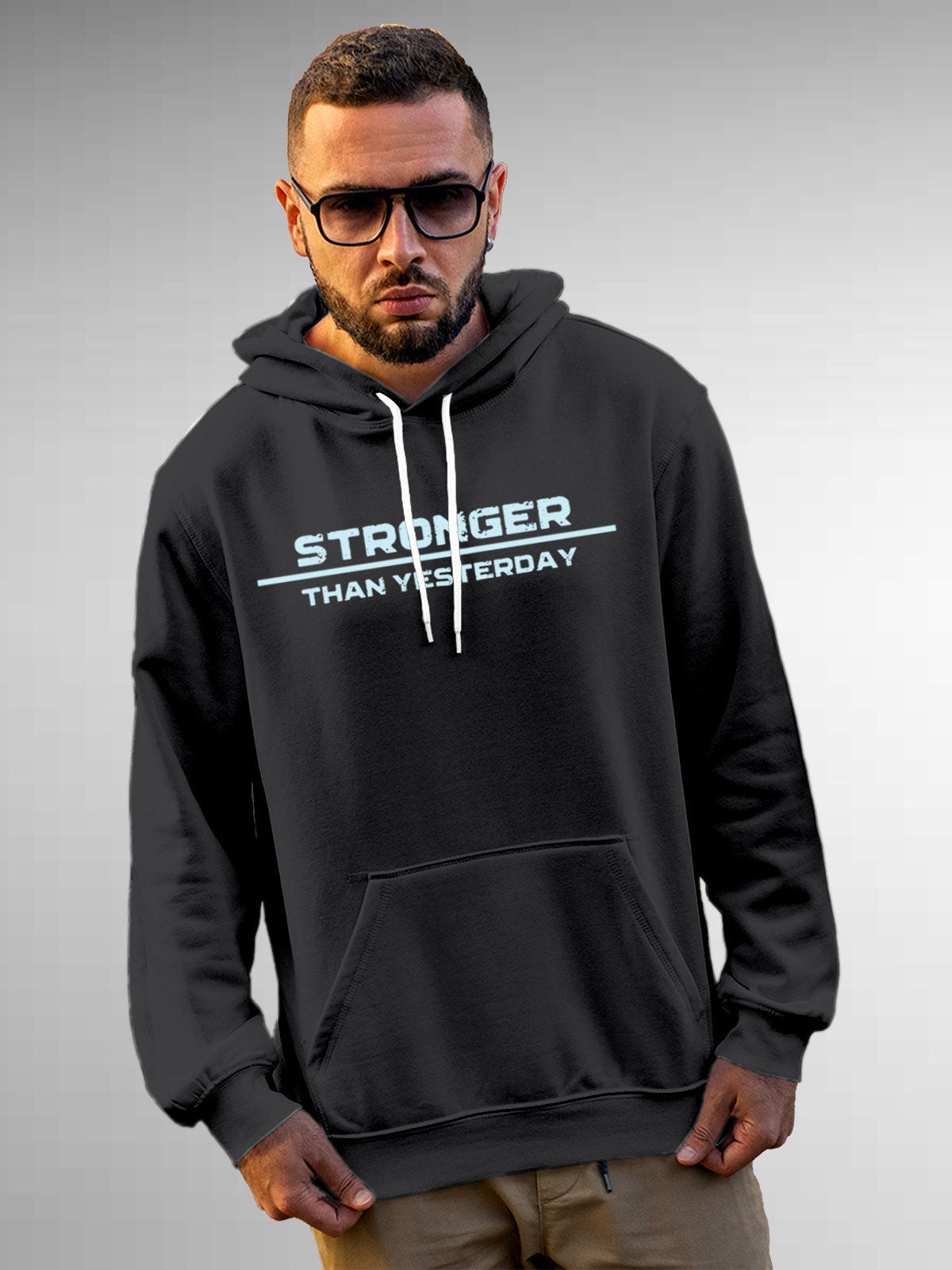 Model wearing Men's Dark Grey Hoodie Sweatshirt with 'Stronger Than Yesterday' design, offering effortless style and premium comfort