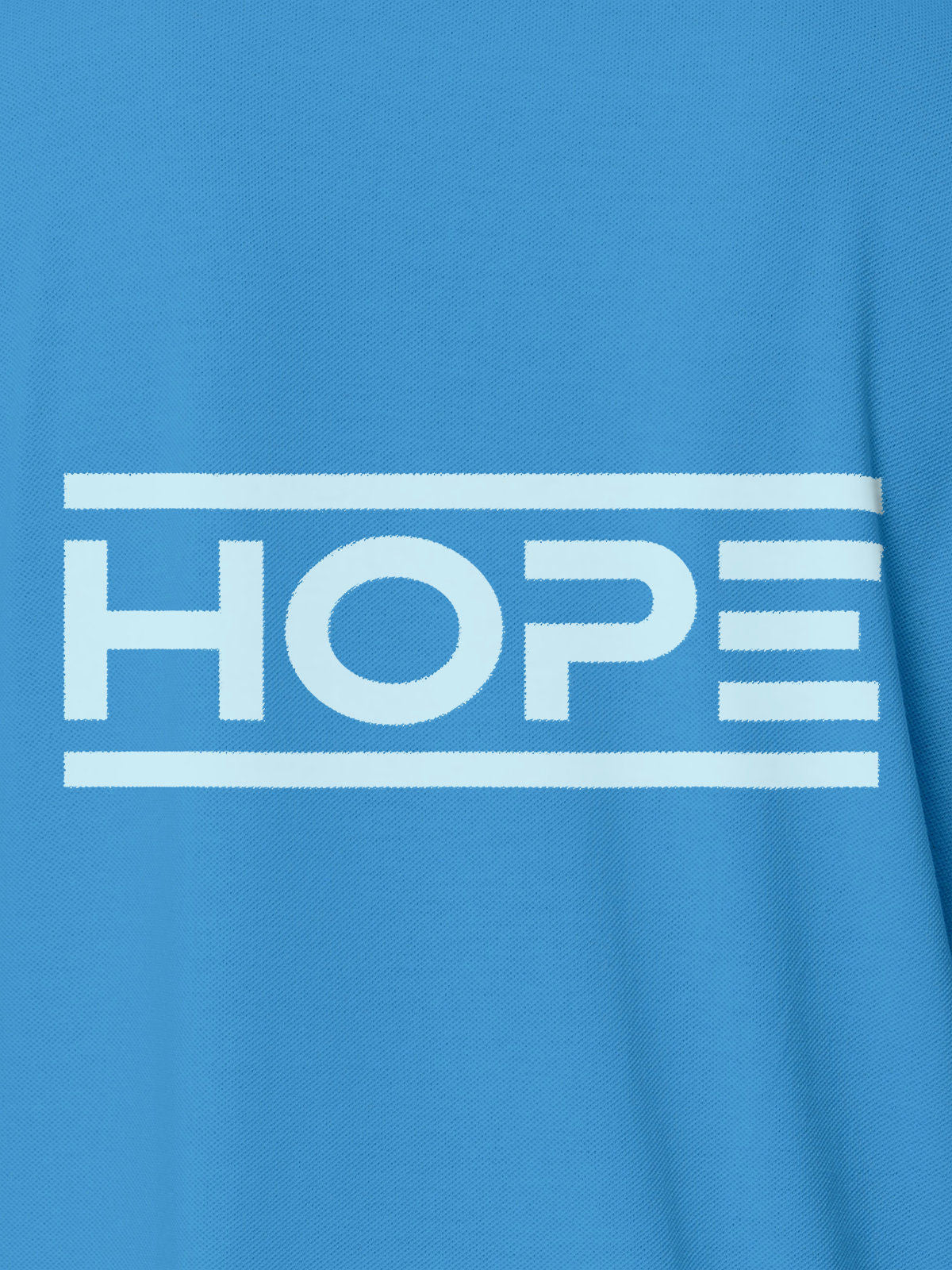 Close up of 'Hope' design on Women's Blue Polo T-shirt, highlighting intricate details and vibrant print.