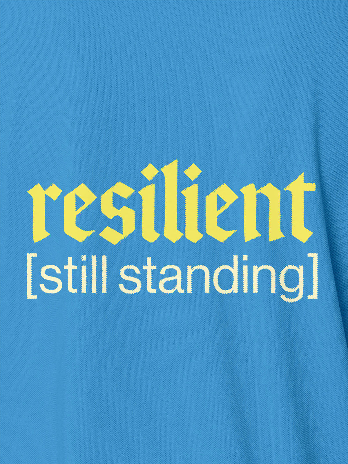 Close up of 'Resilient' design on Men's Blue Polo T-shirt, highlighting intricate details and vibrant print.